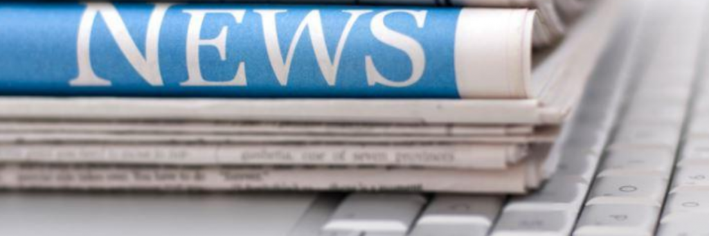Stack of newspapers with "News" clearly visible